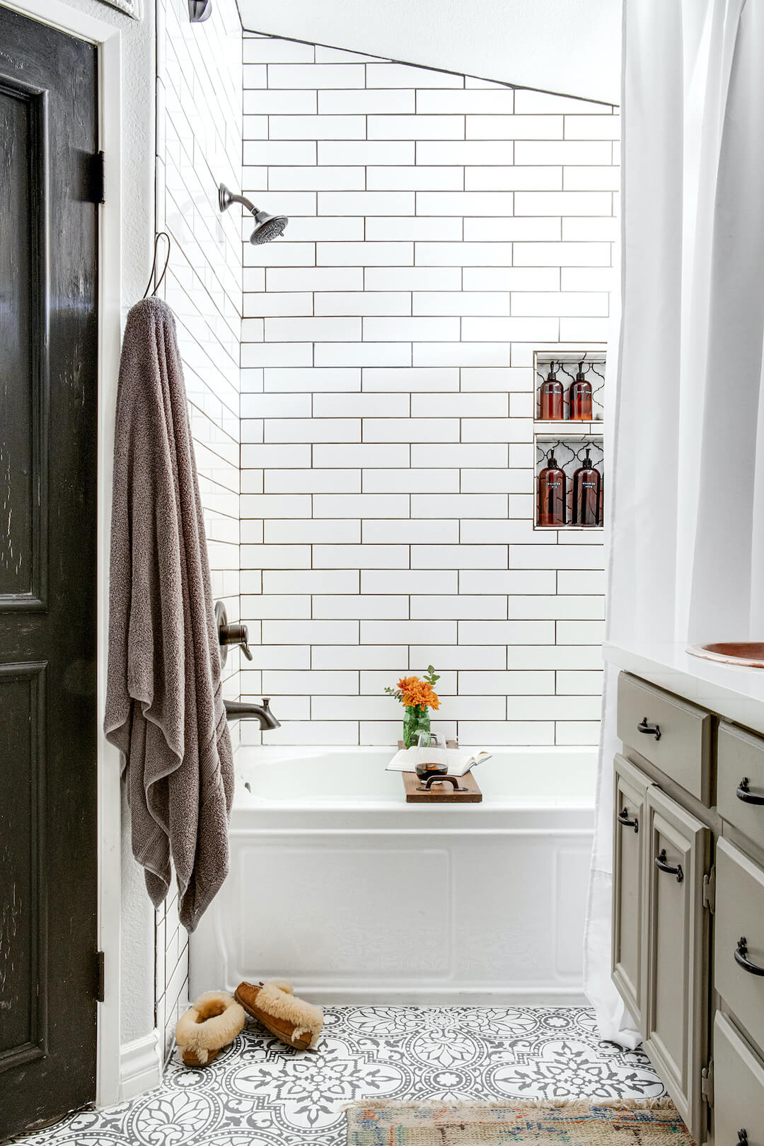 black and white floral mosaic tile in bathroom with white subway tile