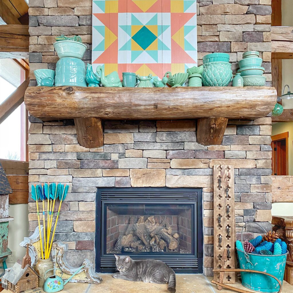 mantel with teal pottery collection