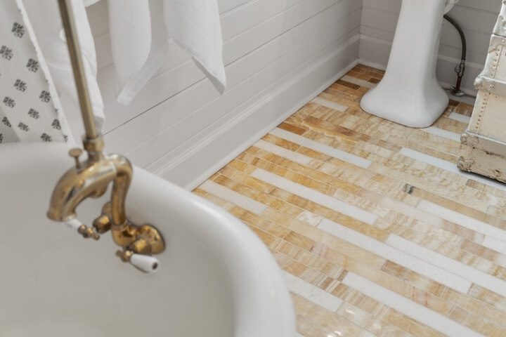 onyx and marble floor tile in renovated bathroom