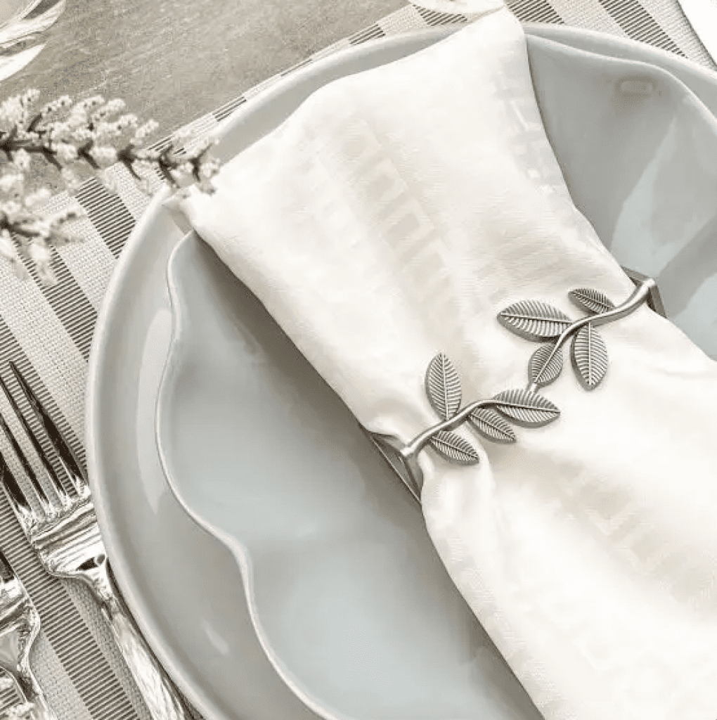 Silver napkin ring that looks like a branch with leaves