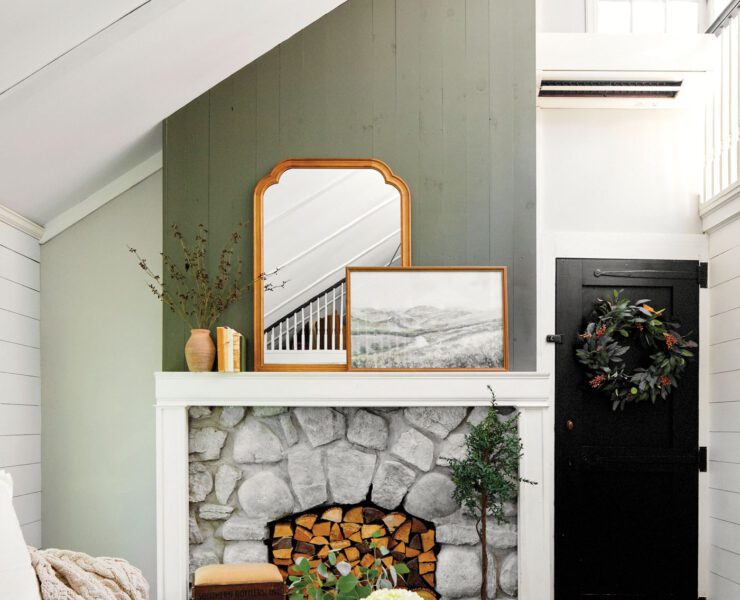 Living room with gren and mantel and cozy decor with a vintage mirror