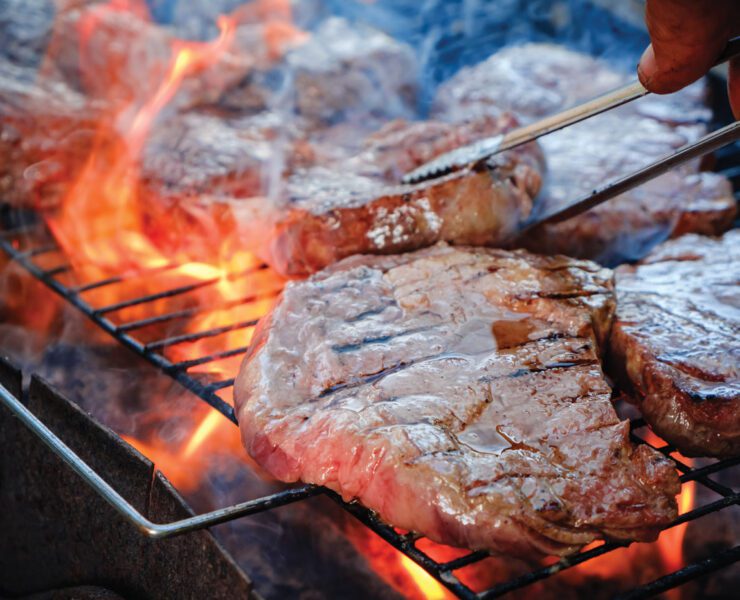steaks searing on grill