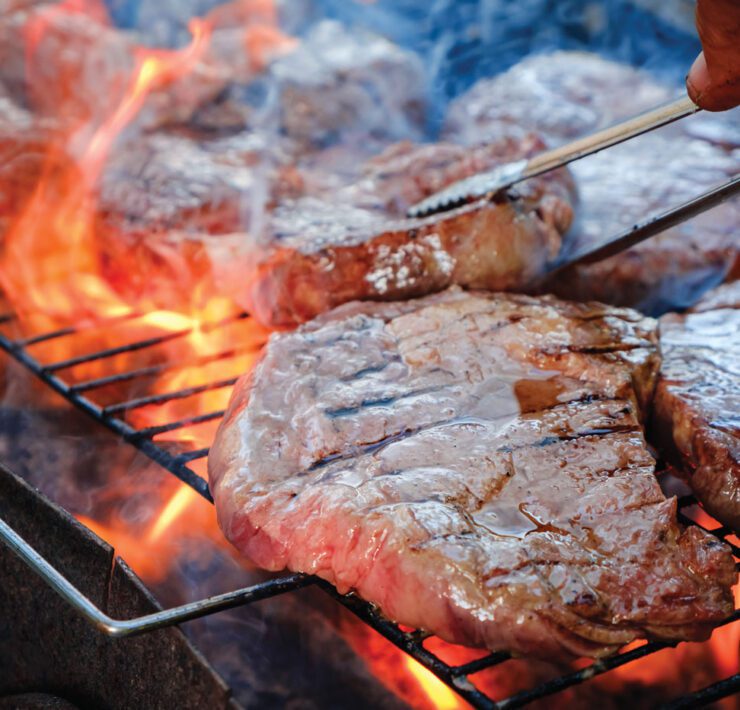 steaks searing on grill