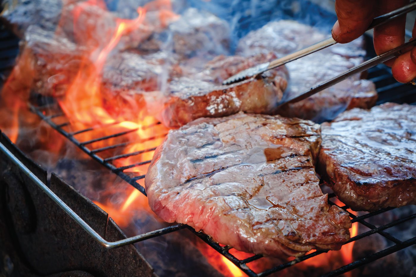 steaks searing on grill