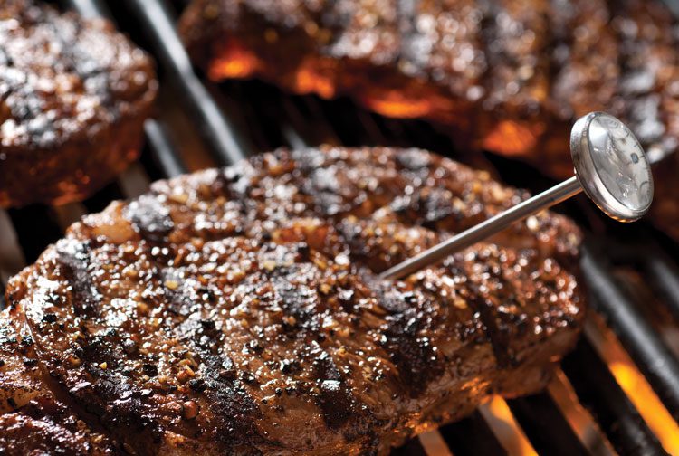 meat probe in steak on grill