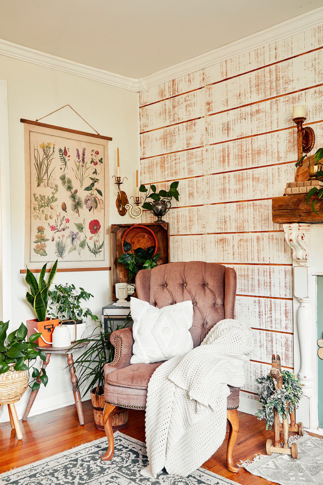 living room with tufted wingback chair and botanical print