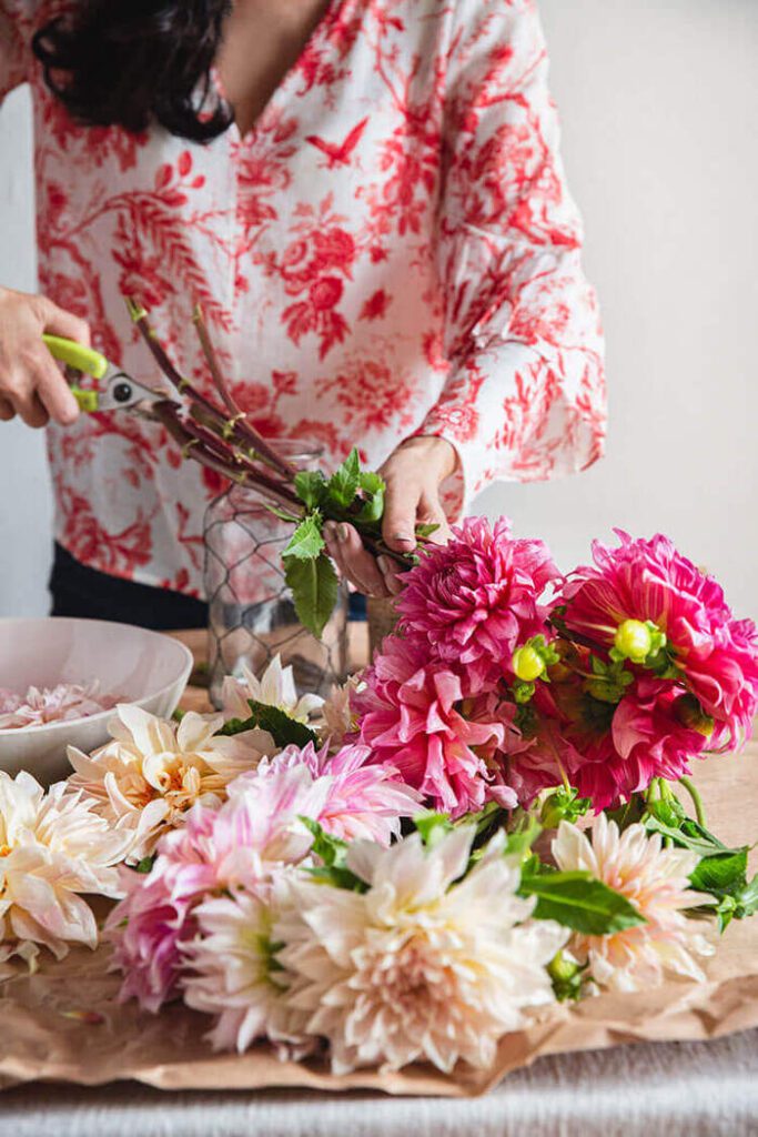 Robin Zachary cutting flowers to make a bouquet