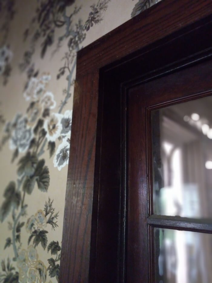 dark wood and wallpaper in old house