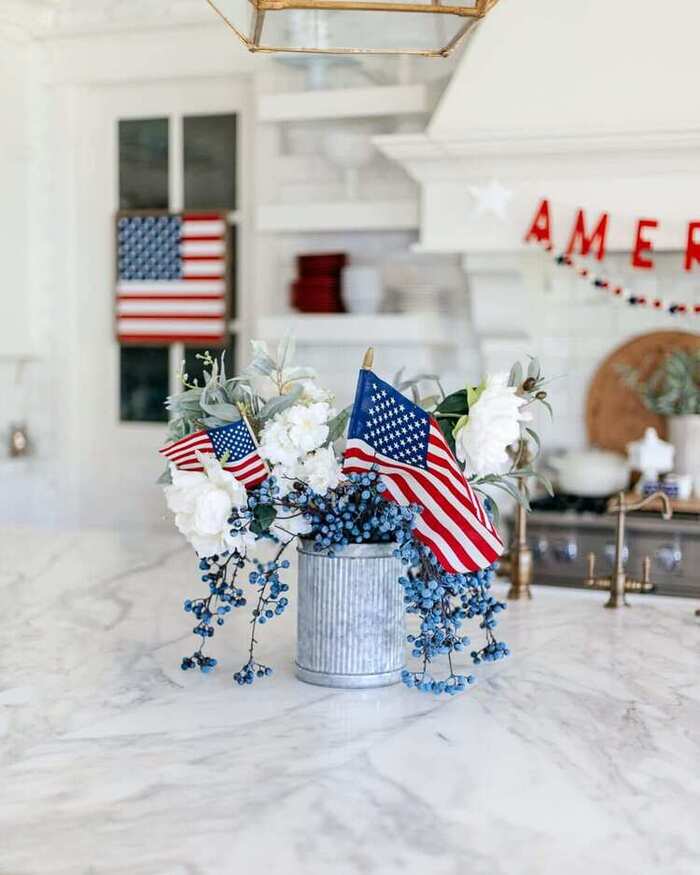 4th of July bouquet with American flags and blueberry stems.