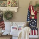 A living room with 4th of July décor, including a blanket ladder displaying American flags.