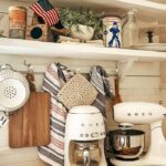 Kitchen counter with white appliances and 4th of July décor and tea towels.