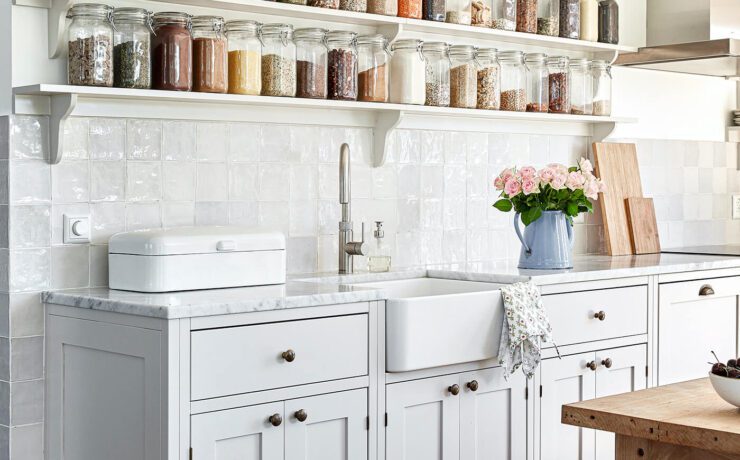 exposed shelves with spices and dry goods in jars