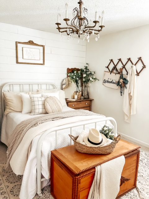 Bedroom with farmhouse decor and bench at the end of the bed