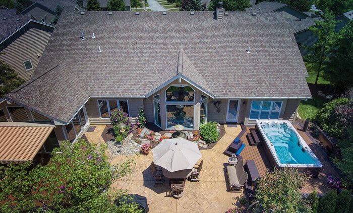 A swim spa in a backyard