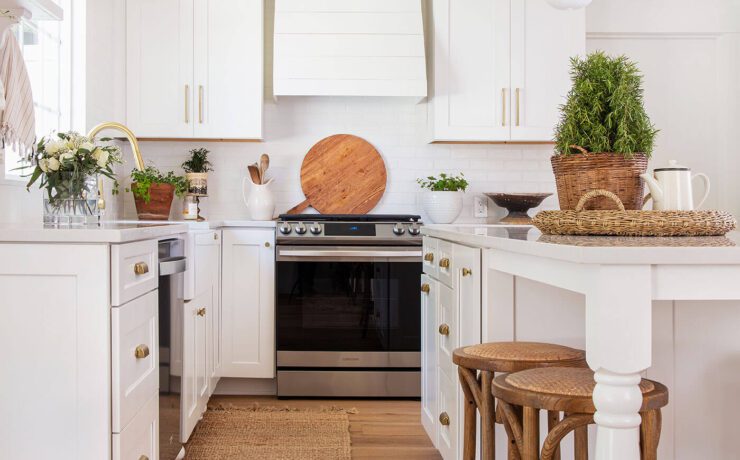 white farmhouse kitchen with wood floor and wood barstools with tips to save on a remodel