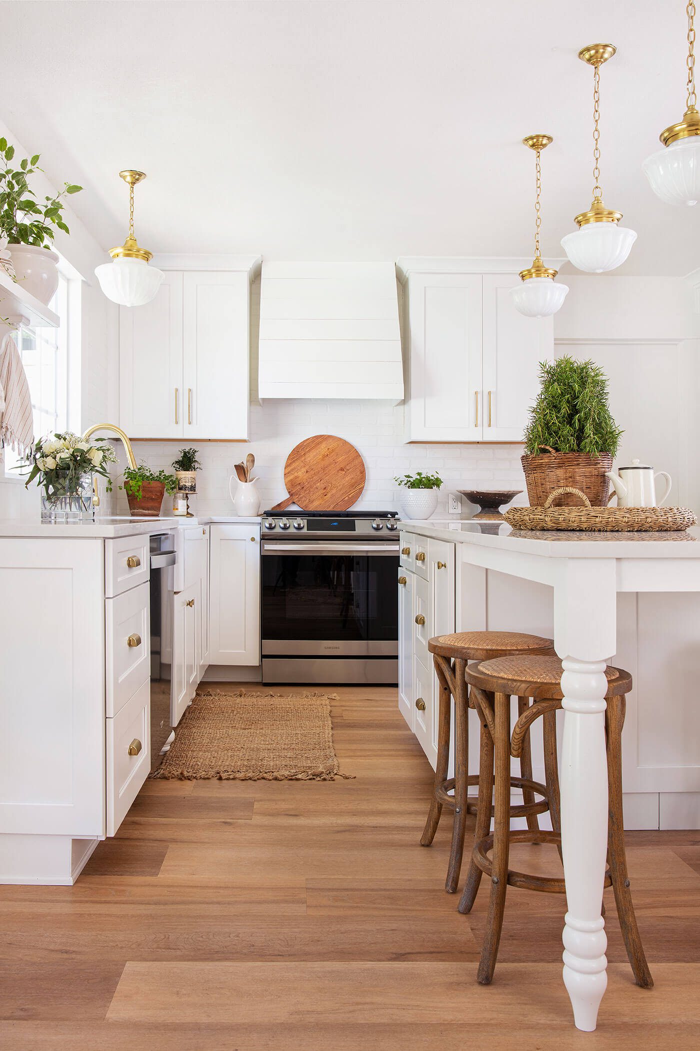 white farmhouse kitchen with wood floor and wood barstools with tips to save on a remodel