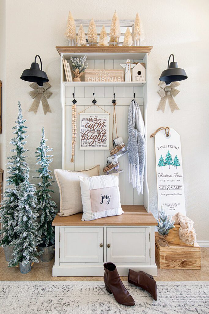 entryway shleving unti with flocked trees and burlap bows
