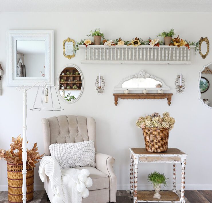 Sitting area with white chair, fall decor and dried hydrangeas for fall farmhouse style