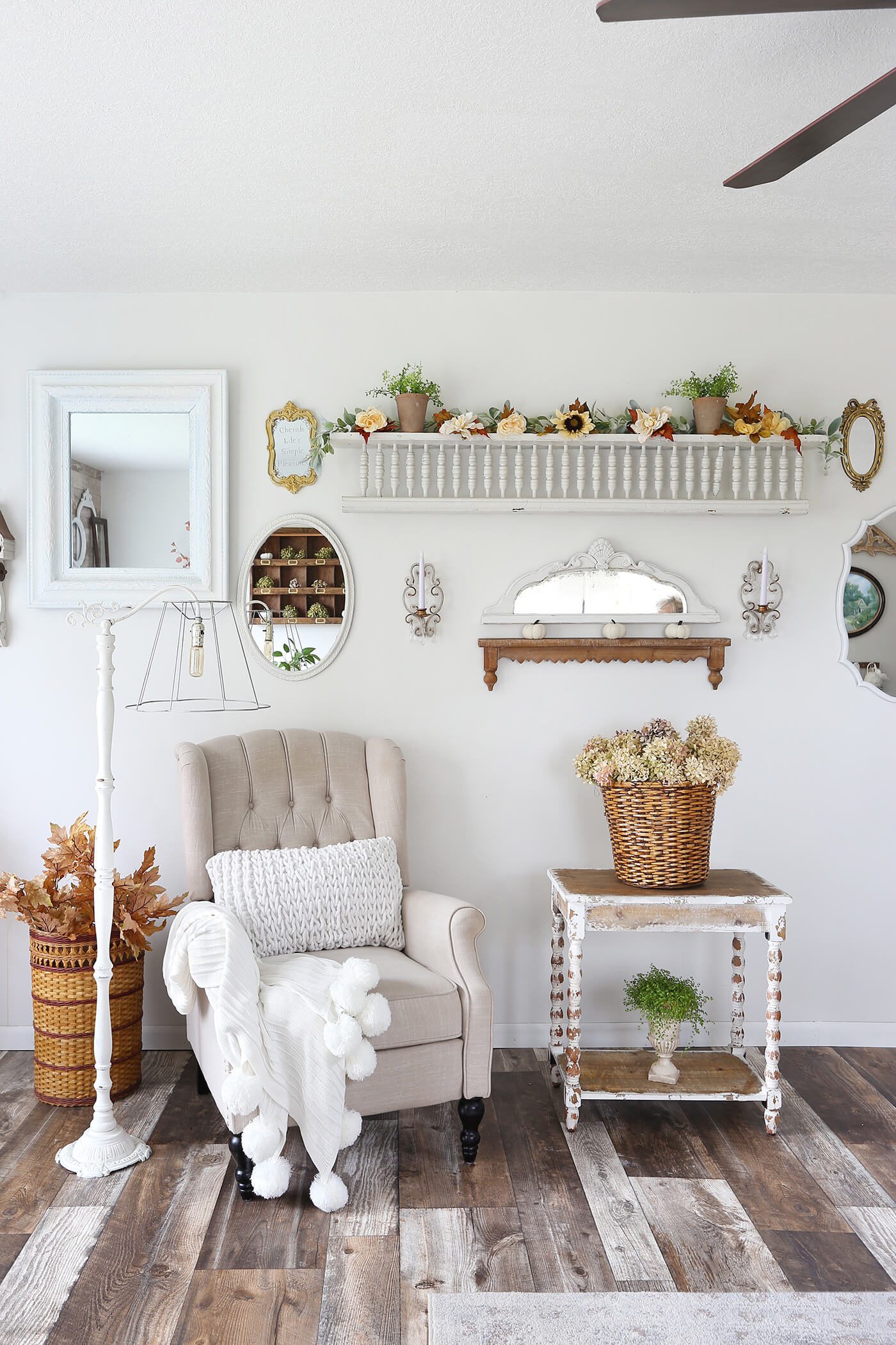 Sitting area with white chair, fall decor and dried hydrangeas for fall farmhouse style