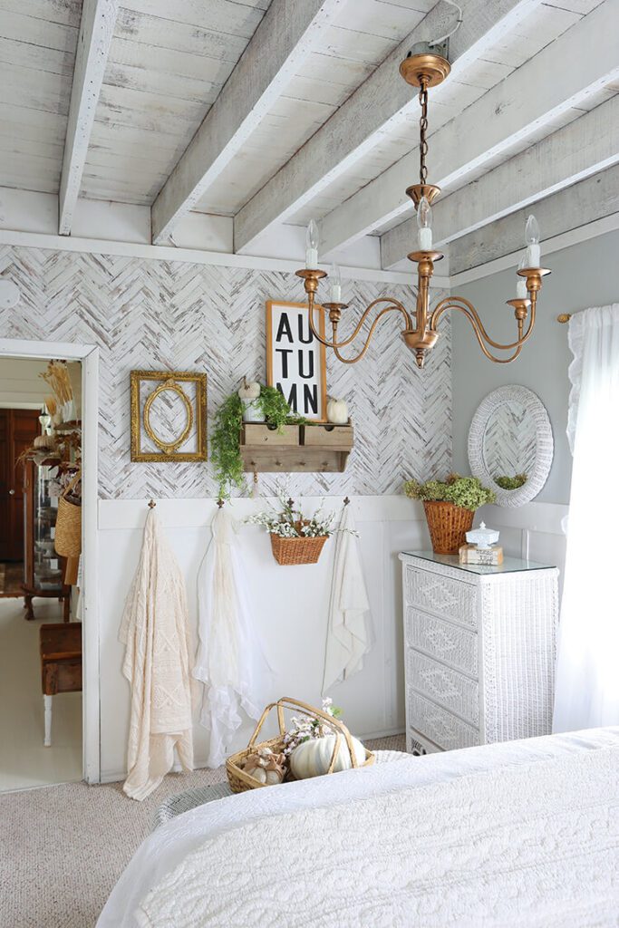farmhouse bedroom with curved chandelier and herringbone pattern