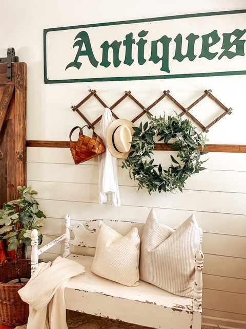 Entryway area with bench seating and hanging decor