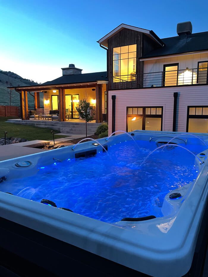 A swim spa next to a farmhouse