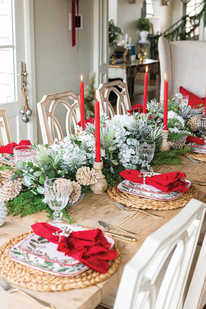 red candles with greenery centerpiece