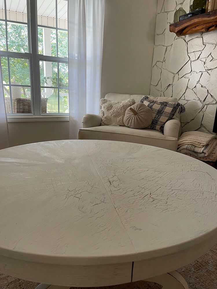 Top of round coffee table with a white crackle finish