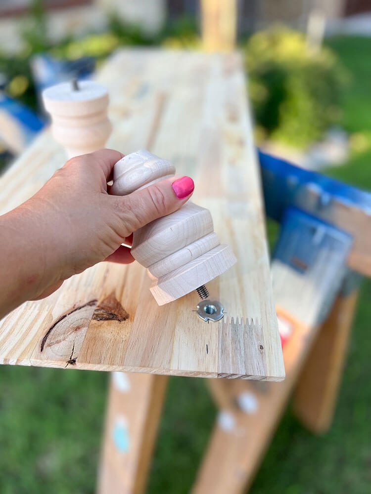 woman outside using wood feet for centerpiece