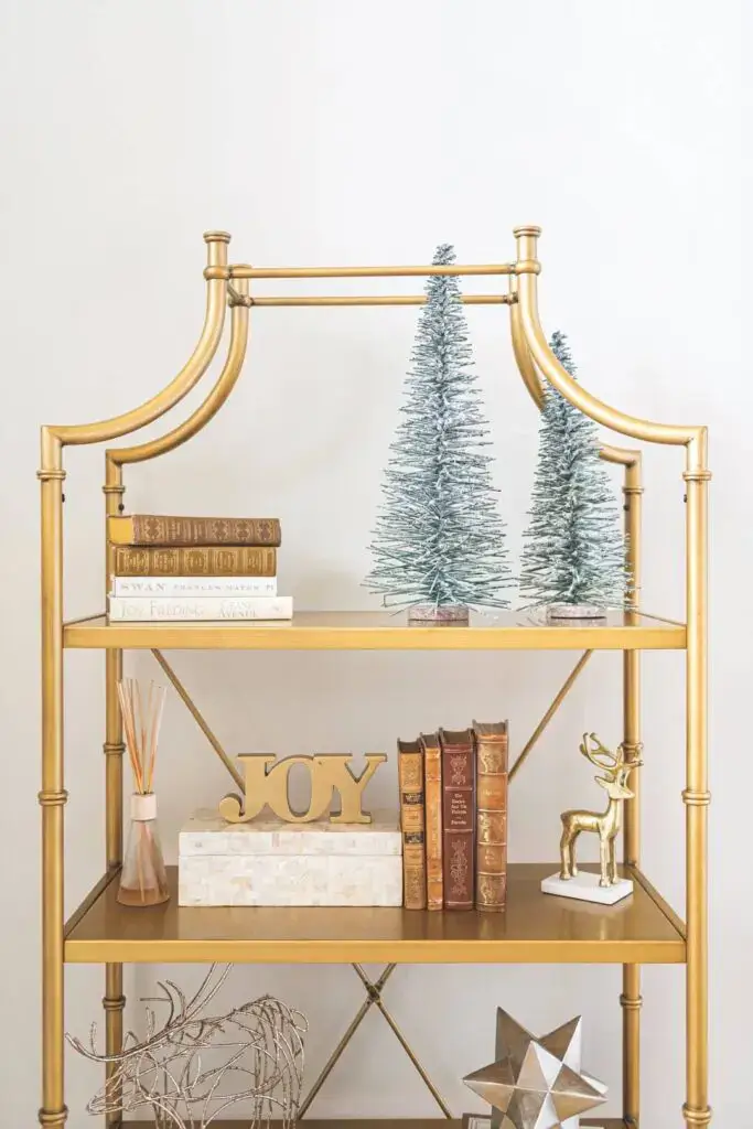 metallic collectibles for a bookcase styled for Christmas
