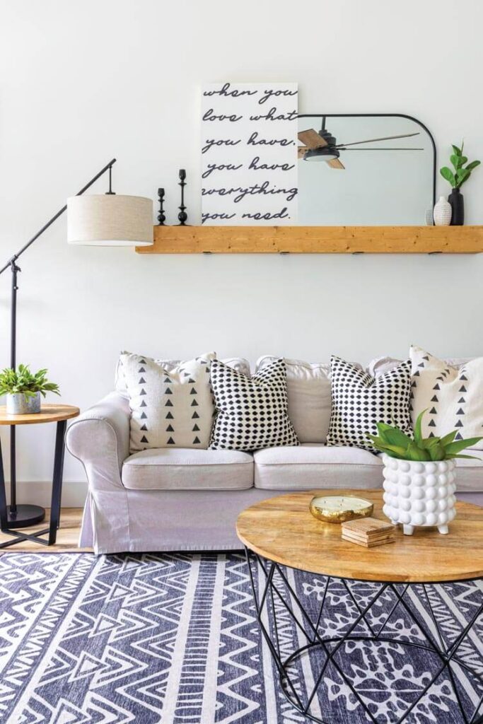 Modern boho farmhouse living room with open shelves and geometric soft goods