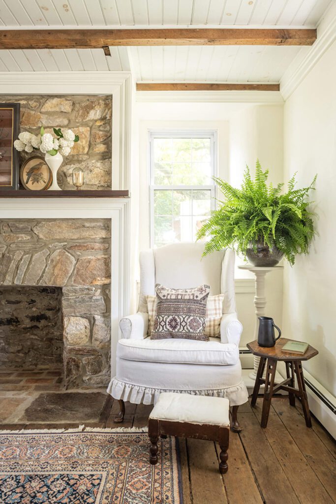 historic home with stone fireplace and exposed wood ceiling beams