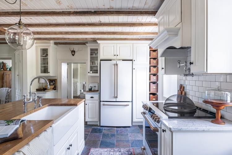 historic home kitchen with island, baskets and subway tile