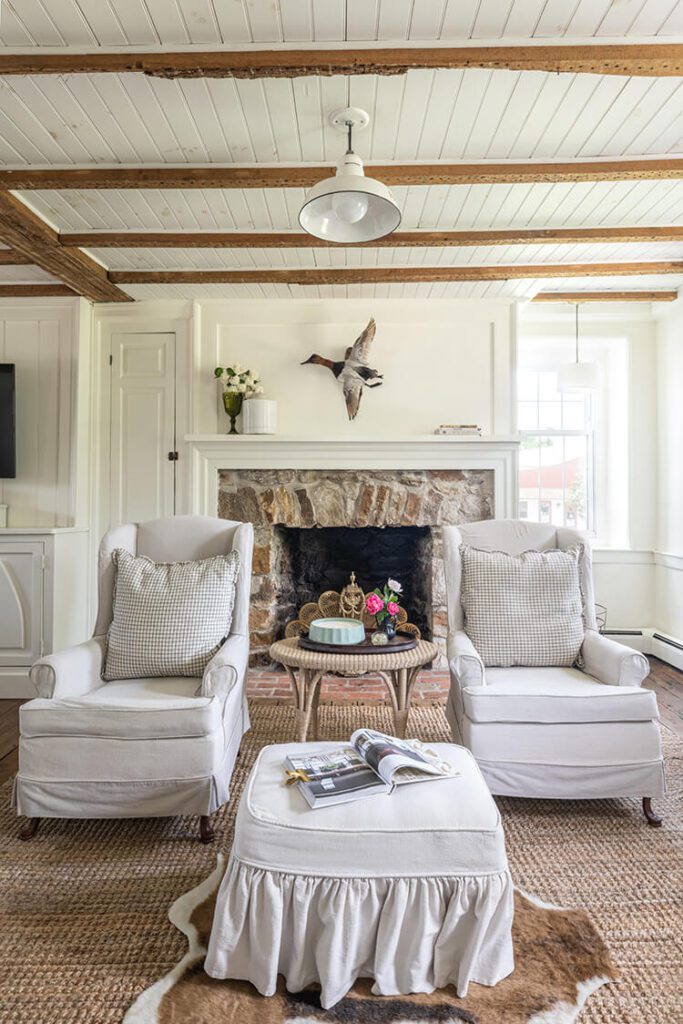 historic home with stone fireplace and wood ceiling