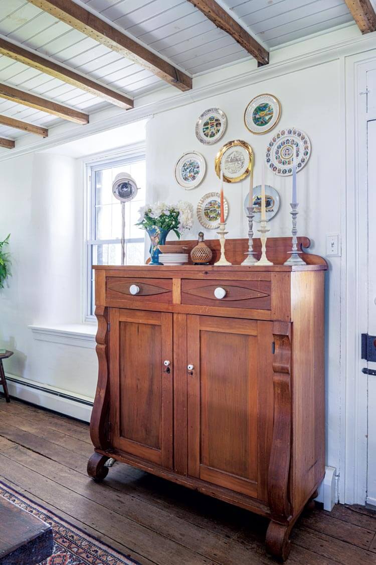 plate collection and tapered candles in historic home