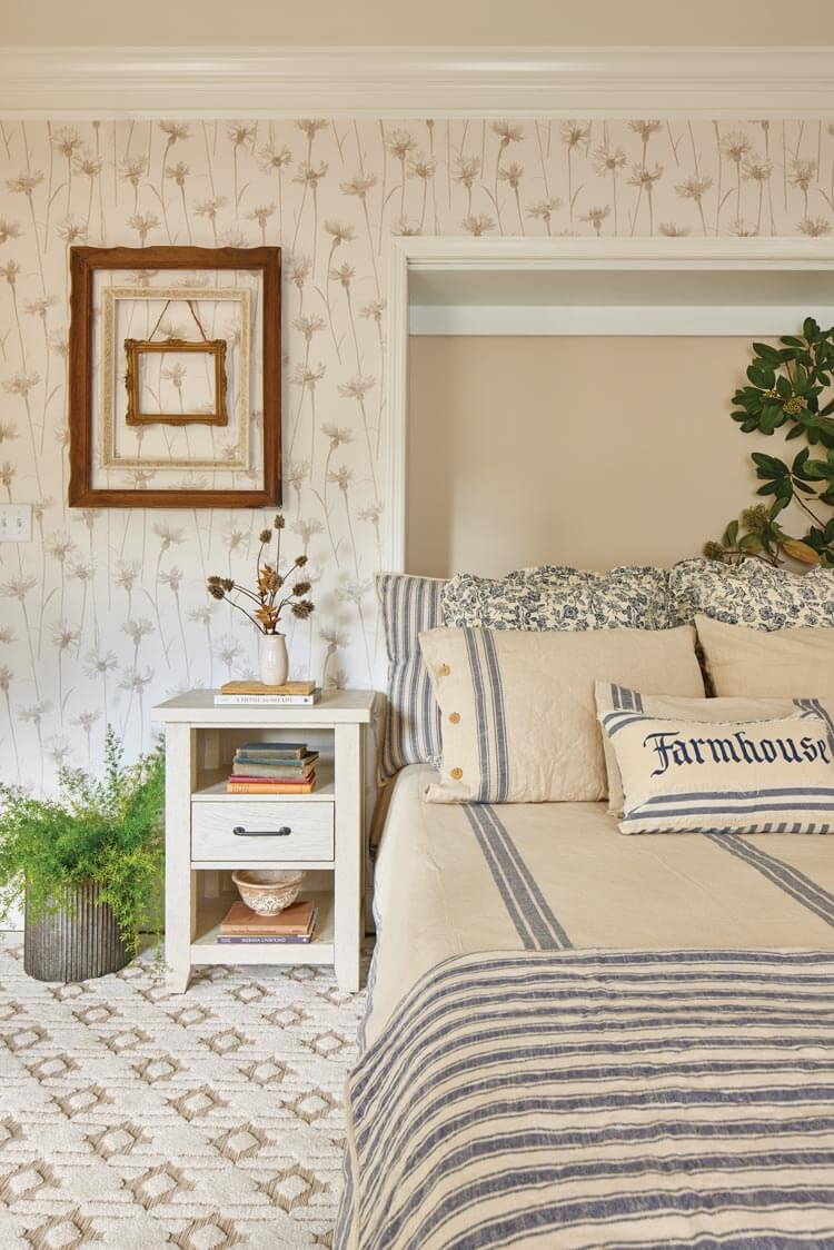 Piper villa bedroom with blue ticking bedding and floral wallpaper