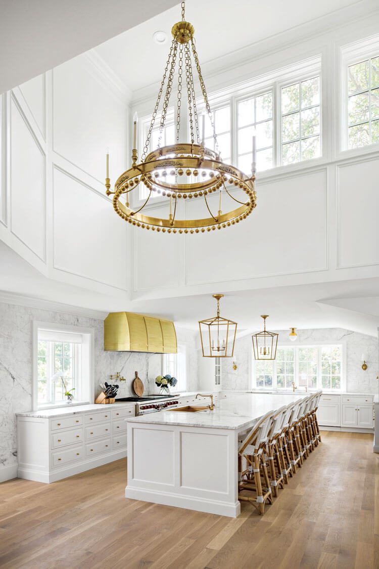 large island in spacious kitchen with gold hood