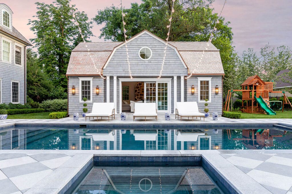 Pool with pool house in farmhouse style