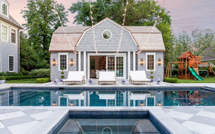Pool with pool house in farmhouse style