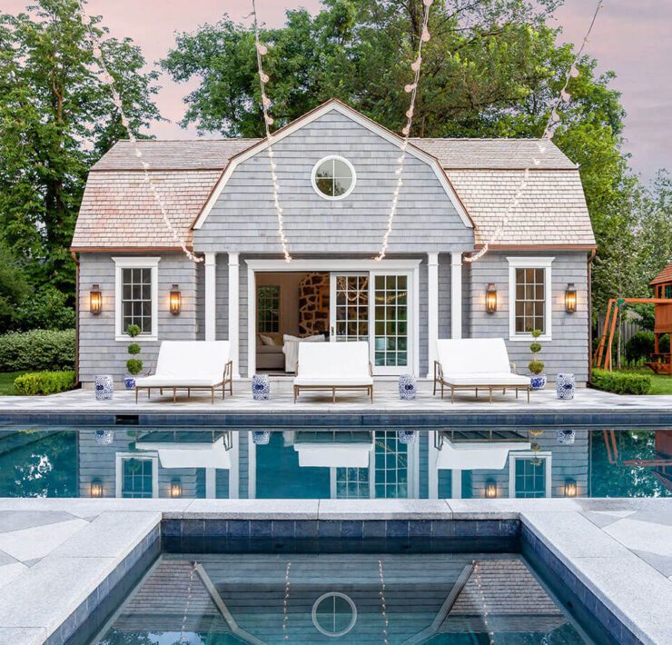 Pool with pool house in farmhouse style