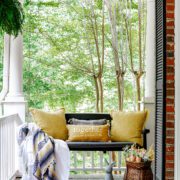 Covered porch with hanging swing and outdoor spring decorating