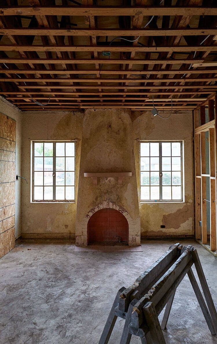 Old room halfway done for historic renovation with beautiful mantel in place