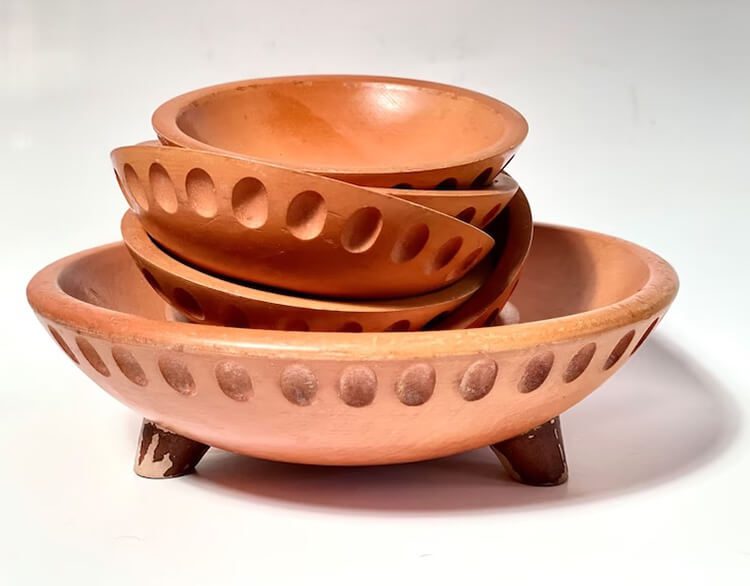 Stack of vintage bowls with legs on a white background