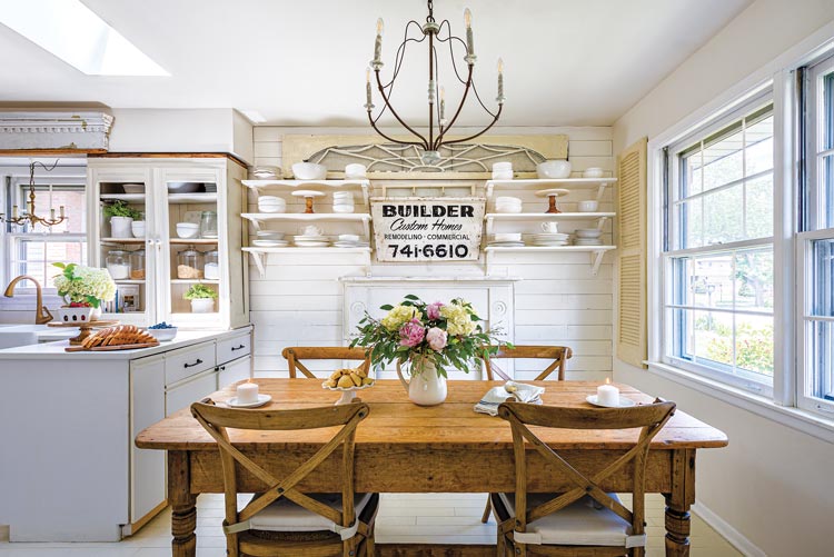 dining area with exposed shelves and vintage sign