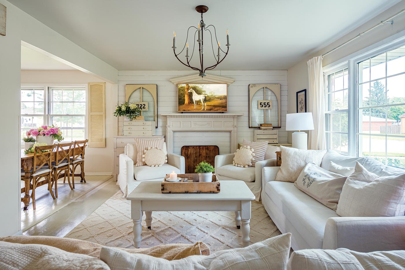 neutral living room with vintage windows and signs