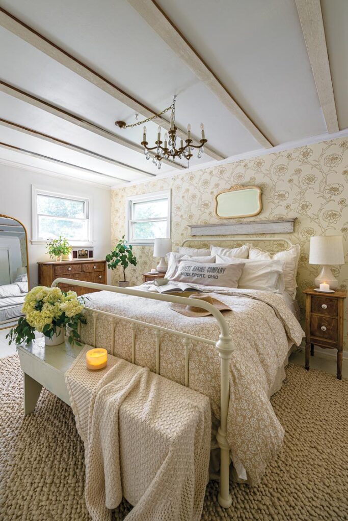 bedroom with vintage style floral wallpaper and metal bedframe