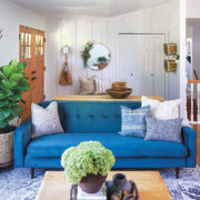 mid century modern farmhouse style in living room with blue sofa and modern wall art