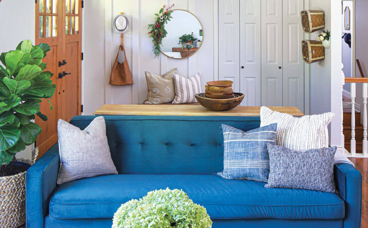 mid century modern farmhouse style in living room with blue sofa and modern wall art