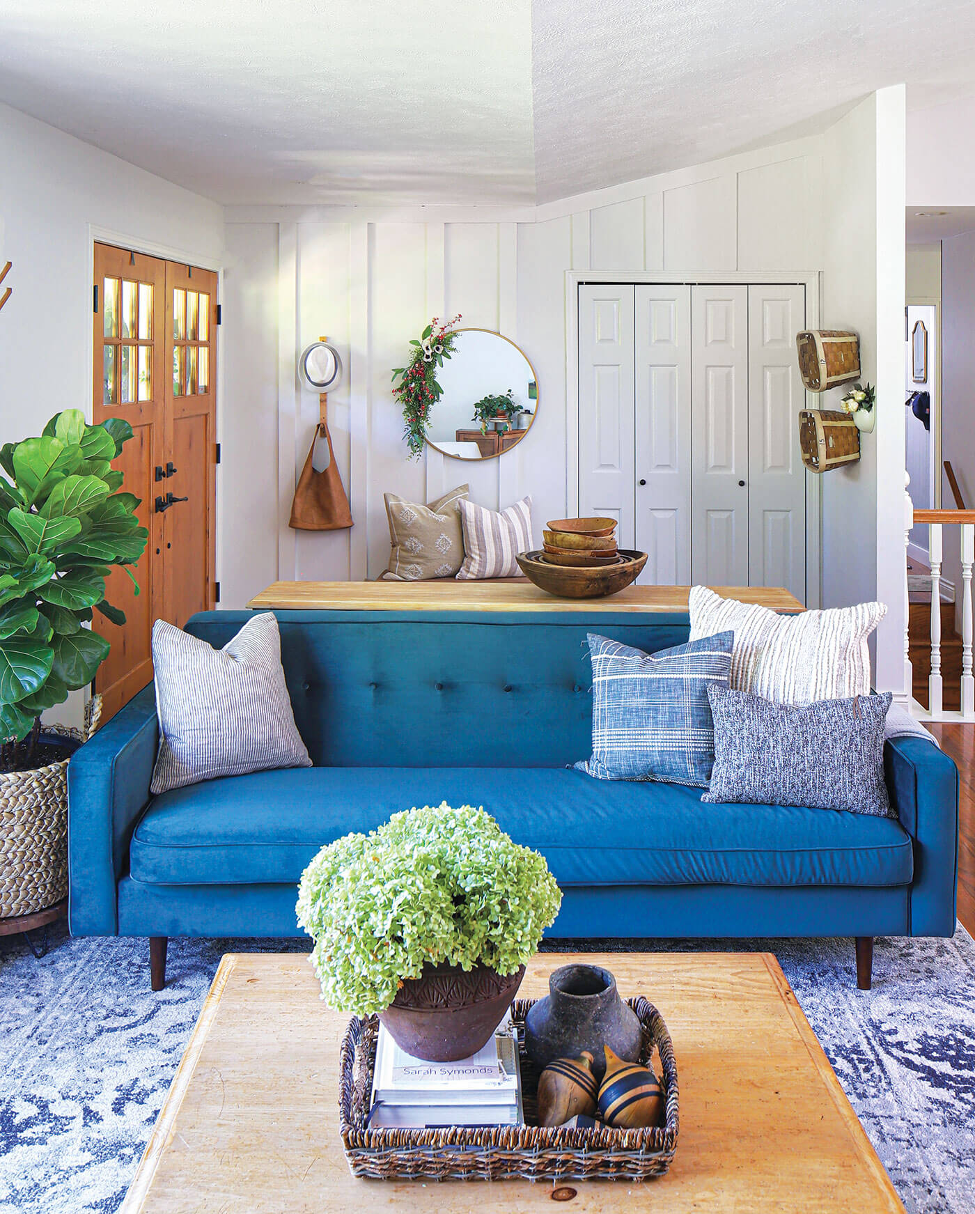 mid century modern farmhouse style in living room with blue sofa and modern wall art