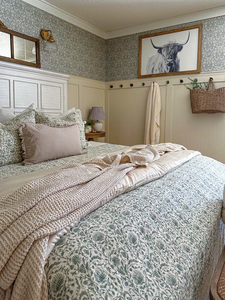 cozy cottage bedroom with mirror, bench and Badcock furniture wood bedframe